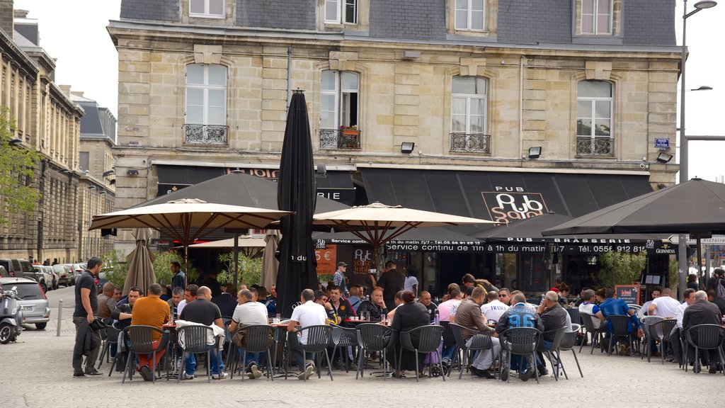 Place de la Victoire featuring outdoor eating and café scenes as well as a large group of people