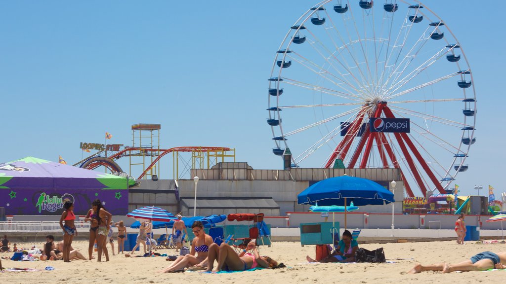 Ocean City Beach featuring a sandy beach and rides as well as a small group of people