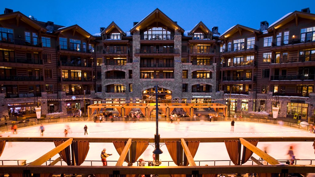 Northstar California Resort showing ice skating and a hotel as well as a small group of people