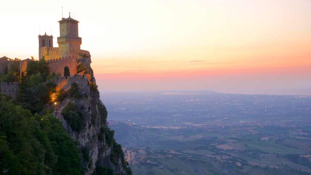 Guaita Tower which includes a sunset, heritage architecture and mountains