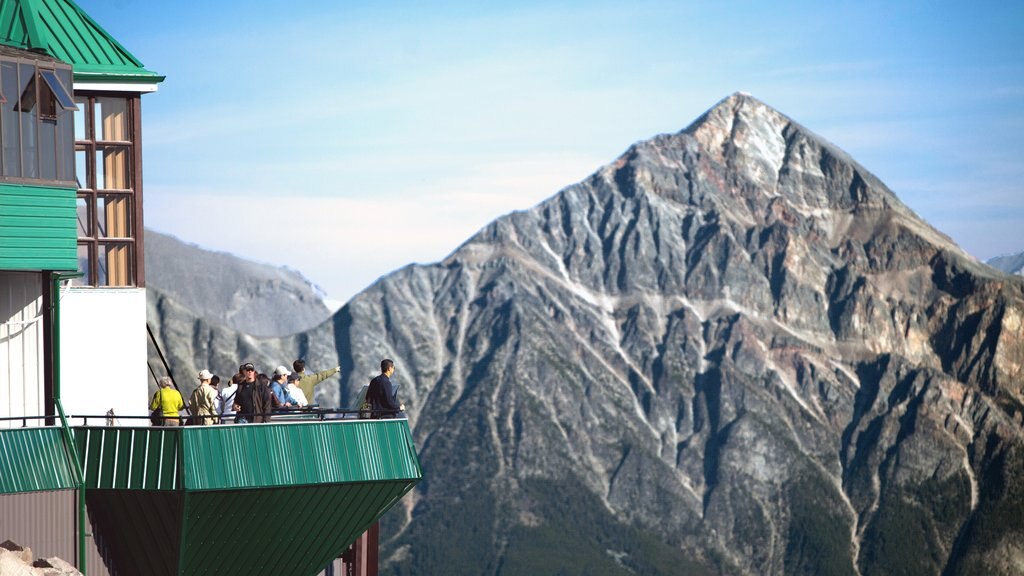 Jasper Tramway showing mountains and views as well as a small group of people