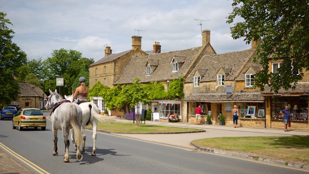 Broadway showing horse riding, street scenes and a small town or village