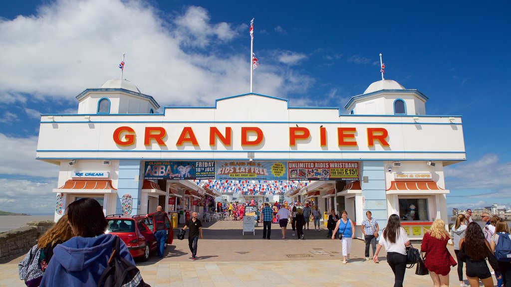 The Grand Pier which includes signage and a festival as well as a large group of people