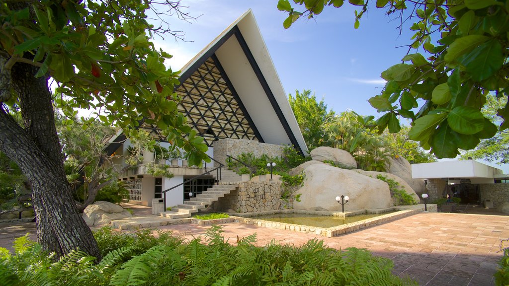 Capilla de la Paz showing a church or cathedral and a pond