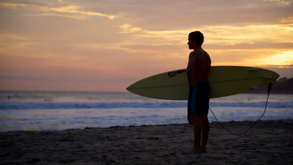 Zicatela Beach showing surfing, a sunset and a beach