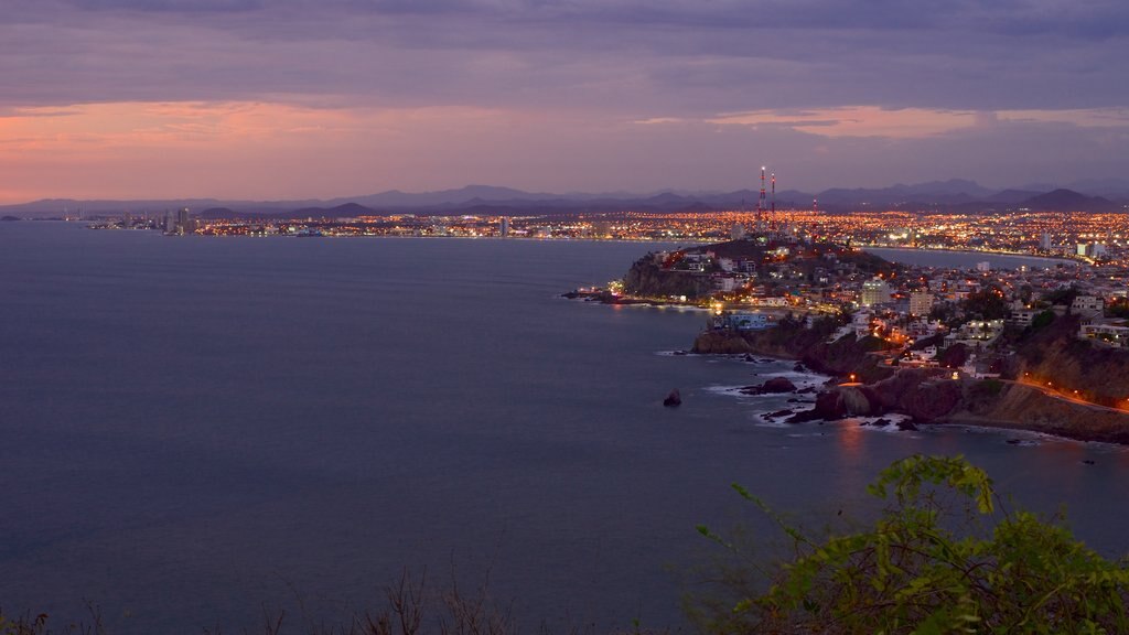 El Faro Lighthouse featuring night scenes, a coastal town and rugged coastline