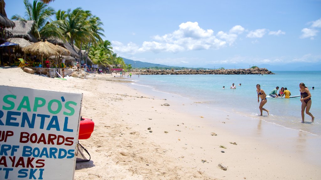 Costa Sur de Nayarit que incluye escenas tropicales, señalización y una playa de arena