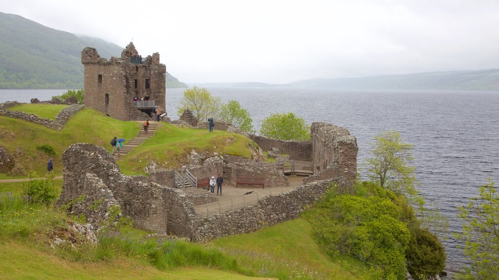 Urquhart Castle featuring a lake or waterhole, building ruins and château or palace