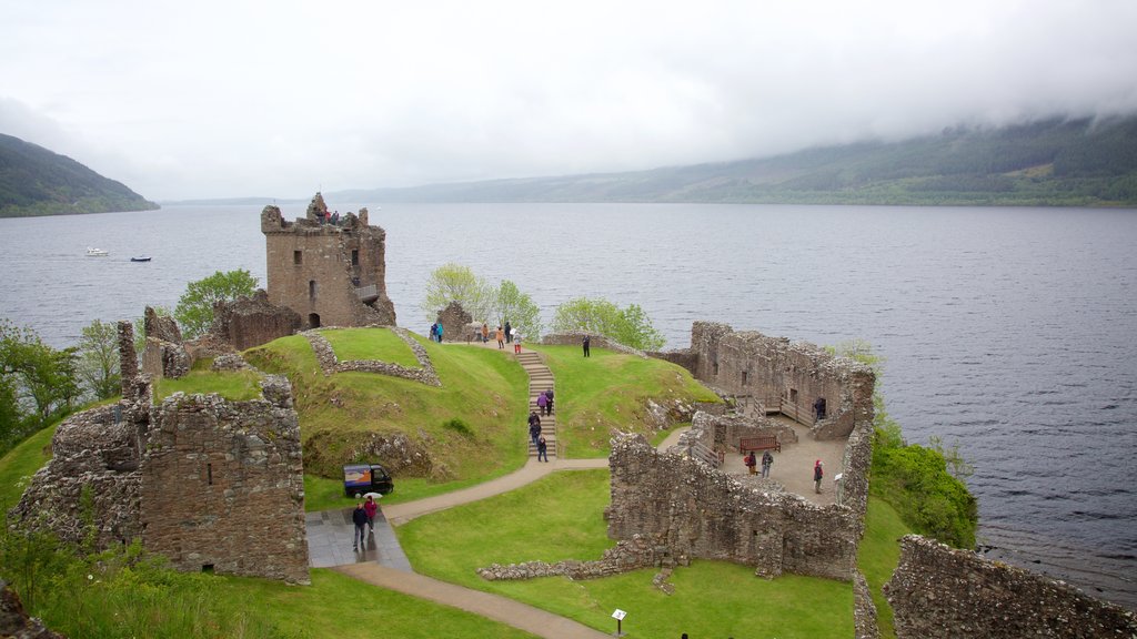 Urquhart Castle featuring building ruins, heritage elements and a lake or waterhole