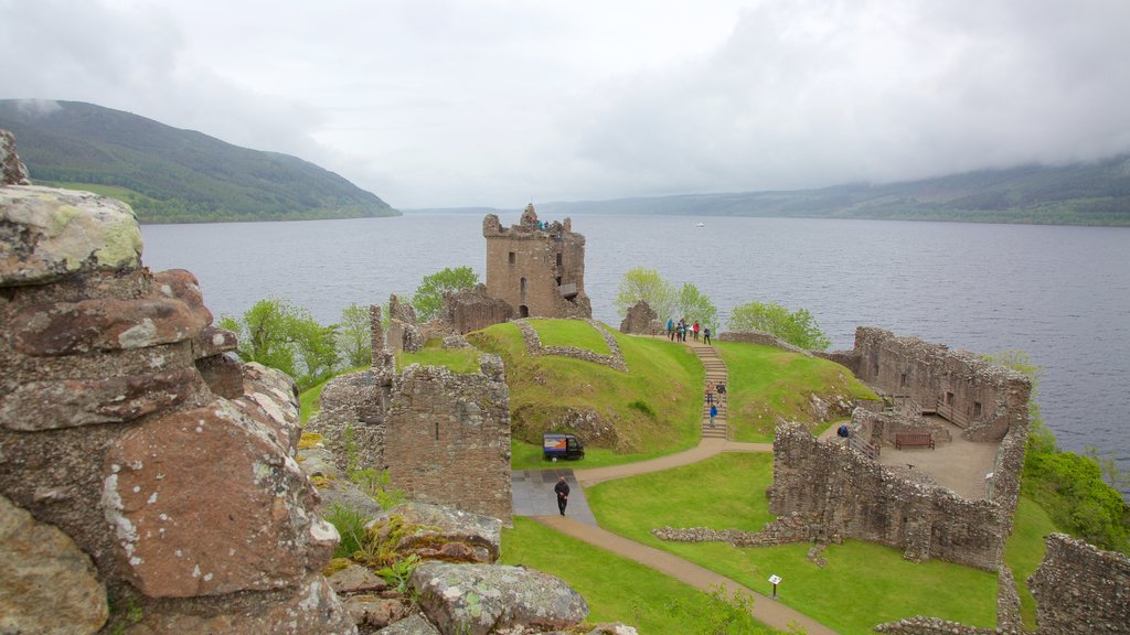 Urquhart Castle featuring a lake or waterhole, heritage elements and building ruins