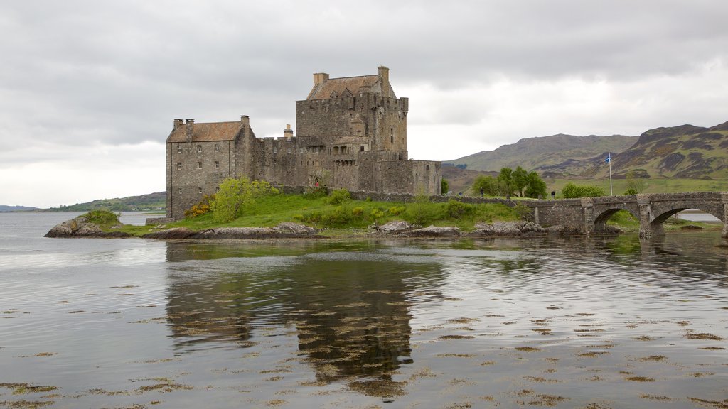 Eilean Donan Castle which includes a lake or waterhole, tranquil scenes and a bridge