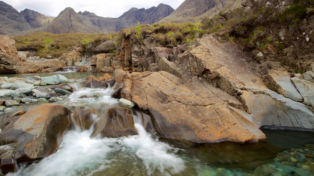 Isle of Skye which includes mountains, tranquil scenes and a river or creek