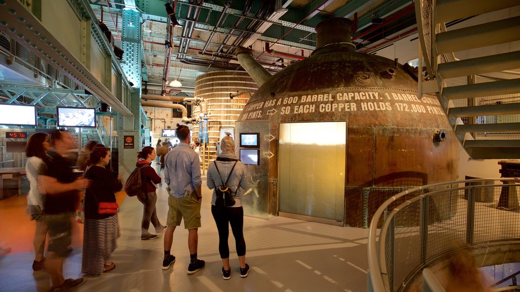 Guinness Storehouse which includes signage and interior views as well as a small group of people