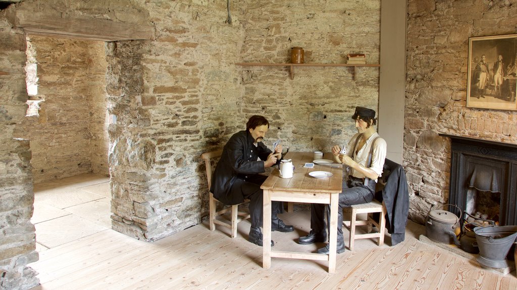 Cork City Gaol showing an administrative building, heritage elements and a statue or sculpture