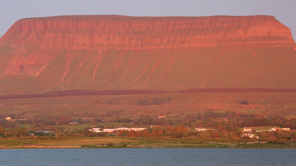 Ben Bulben which includes mountains, a sunset and a river or creek