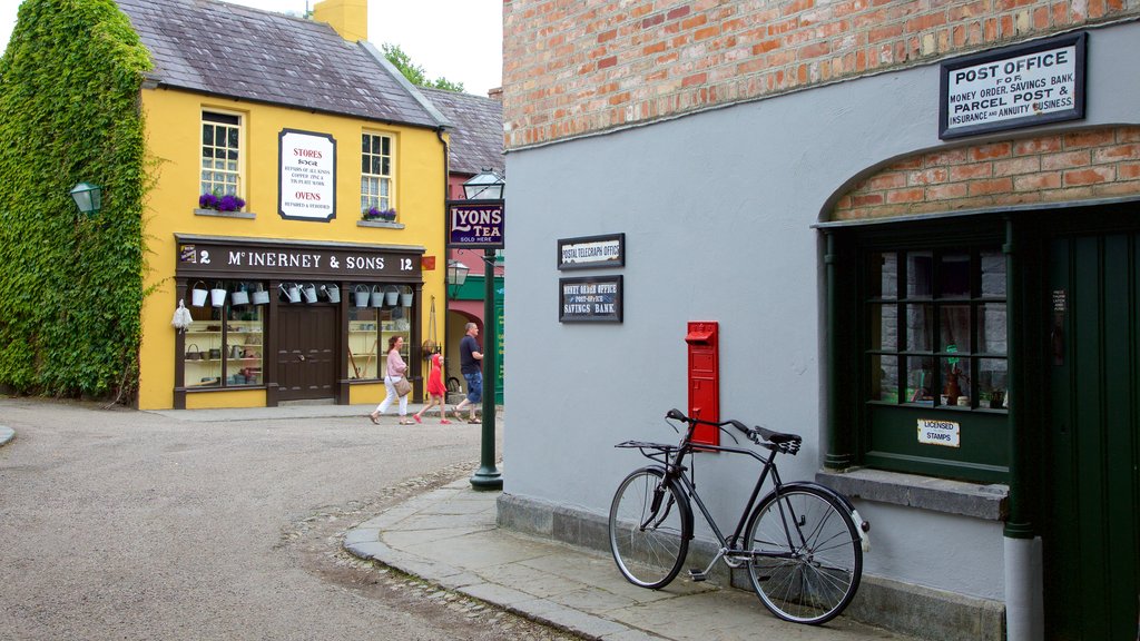 Bunratty Castle and Folk Park showing street scenes and signage as well as a small group of people