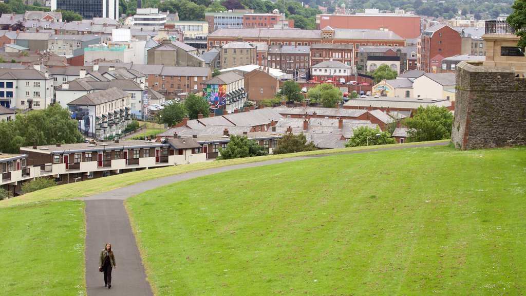 Derry City Walls featuring a city and a park as well as an individual female