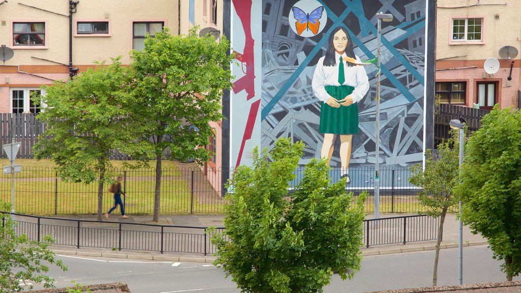 You are Now Entering Free Derry Mural showing outdoor art as well as an individual femail