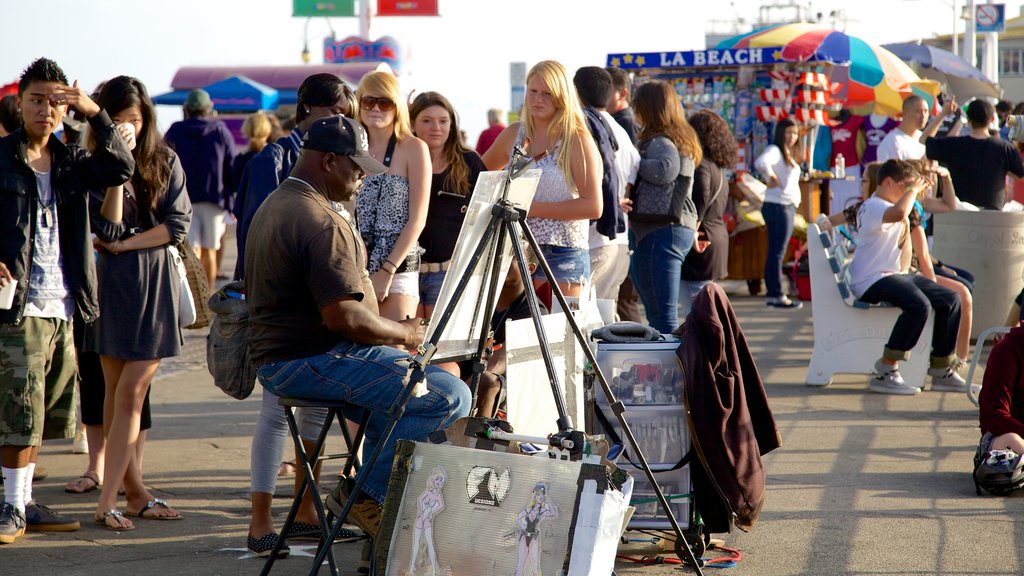 Santa Monica featuring markets and outdoor art as well as a small group of people