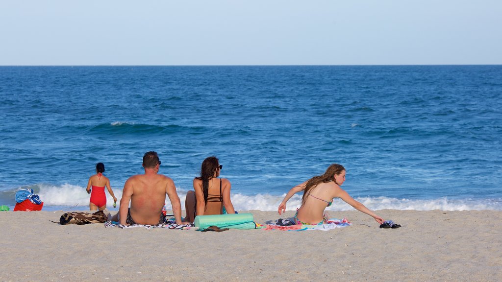 Wrightsville Beach featuring a sandy beach as well as a family