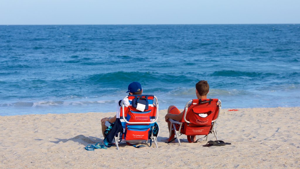 Wrightsville Beach featuring a sandy beach as well as a small group of people