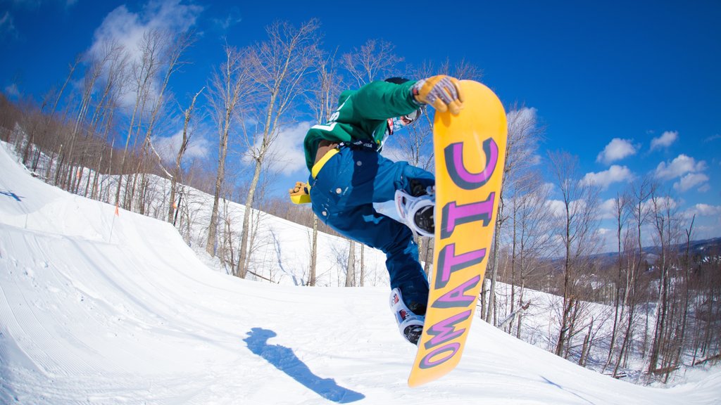 Okemo Valley Golf Club showing snow and snowboarding as well as an individual male