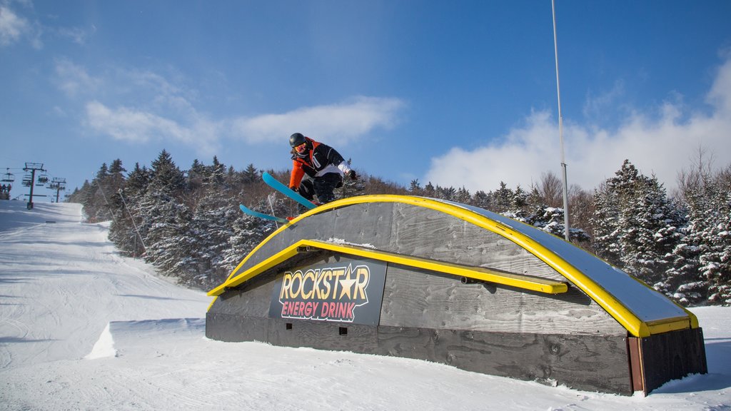 Okemo Mountain Resort showing snow skiing and snow as well as an individual male