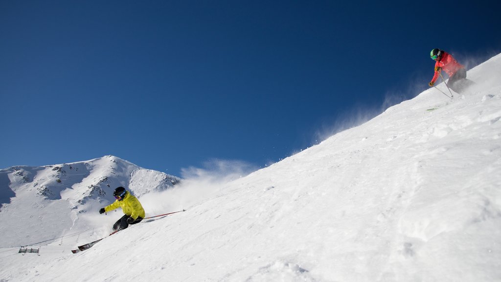 Marmot Basin showing snow skiing and snow as well as a small group of people