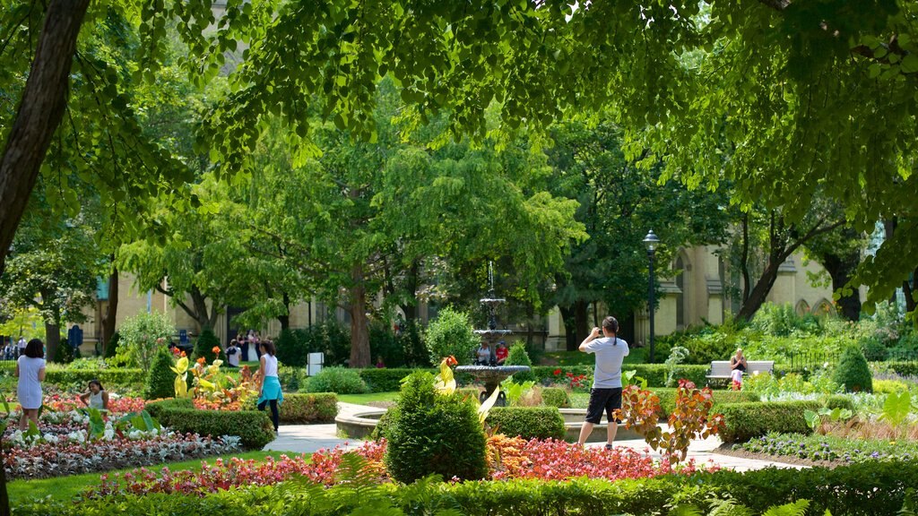 Old Town which includes a garden and a fountain as well as a small group of people