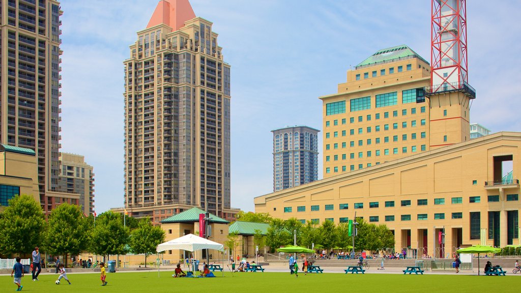 Mississauga Civic Centre showing a city and a park as well as a small group of people