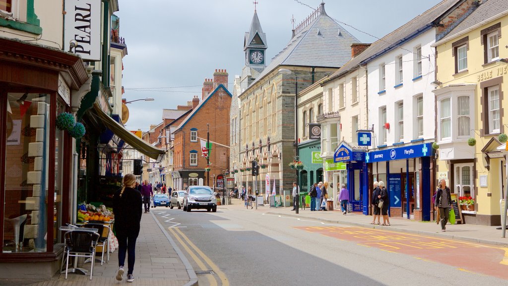 Cardigan featuring street scenes as well as a large group of people