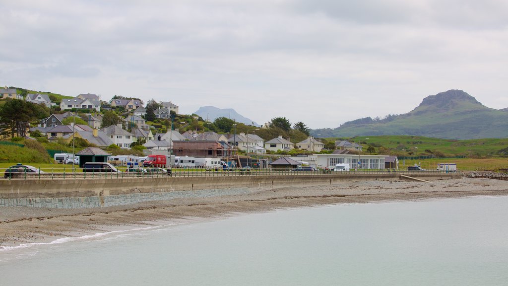 Criccieth which includes a beach and a small town or village