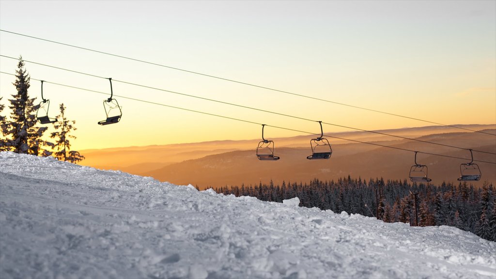 Oslo Winter Park showing a sunset, snow and a gondola