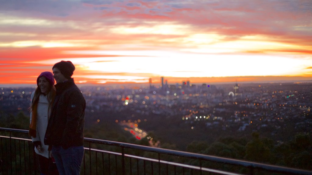 Mt. Coot-Tha showing views and a sunset as well as a couple