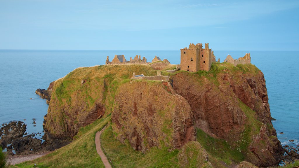 Dunnottar Castle featuring farmland, heritage elements and general coastal views