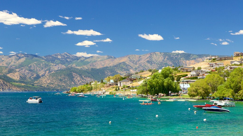 Lake Chelan featuring a river or creek, a city and mountains