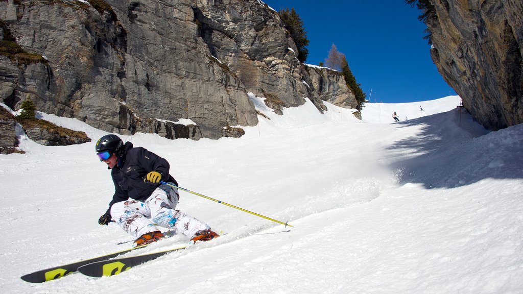 Crans-Montana Ski Resort which includes snow and snow skiing as well as an individual male