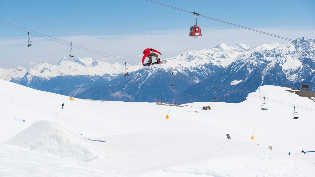 Crans-Montana Ski Resort showing a gondola, snow and snowboarding