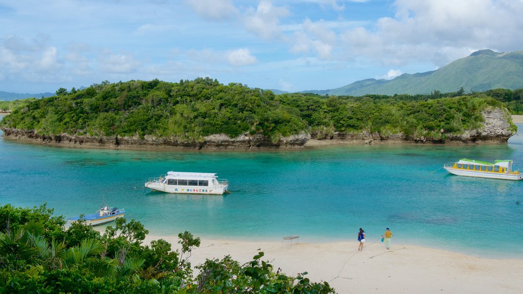 Praia da Baía de Kabira caracterizando uma praia e canoagem assim como um pequeno grupo de pessoas