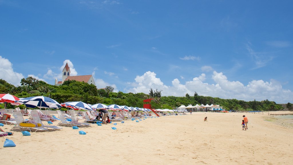 Nirai Beach showing a sandy beach and a coastal town