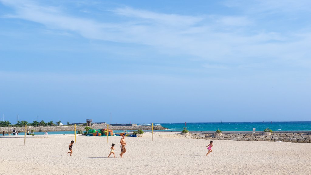 Okinawa showing a beach as well as a family