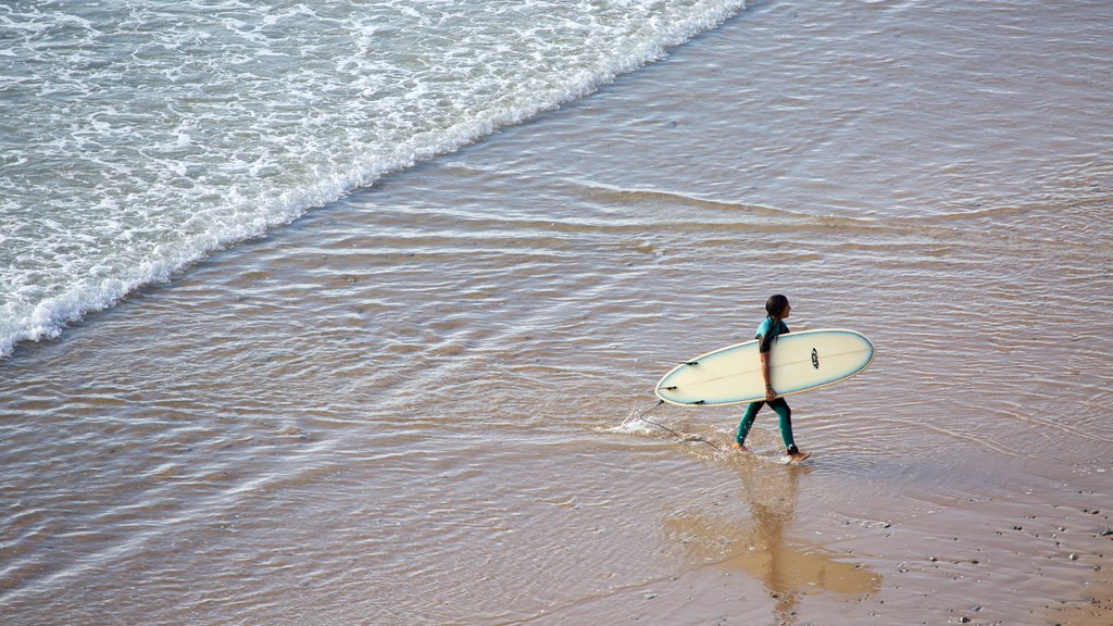 Watergate Bay showing a sandy beach and surfing as well as an individual male