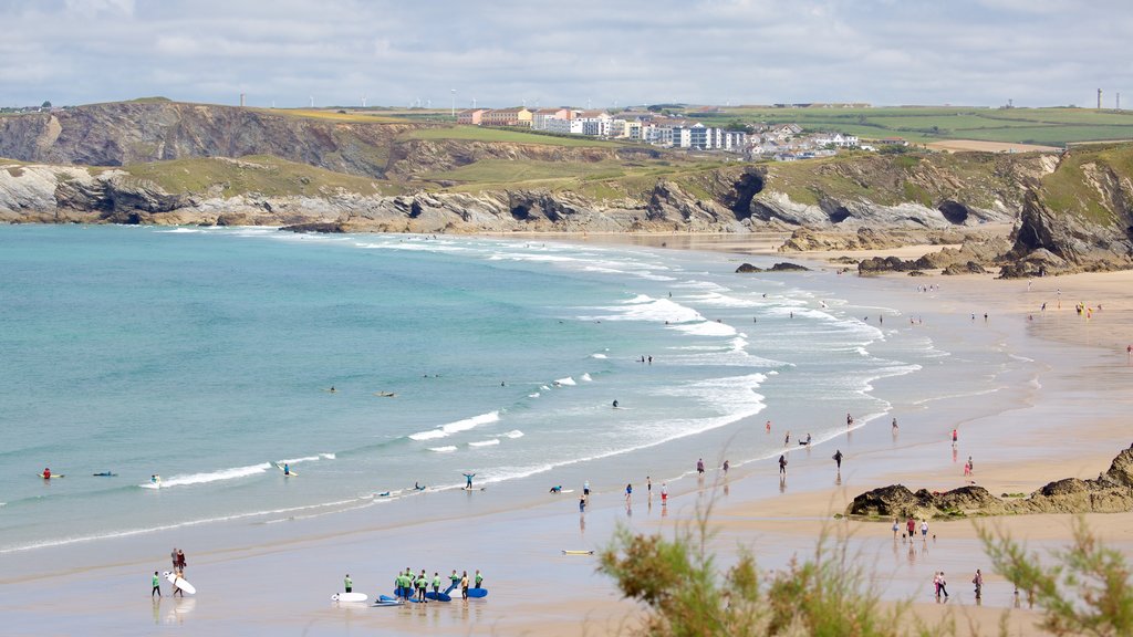 Newquay which includes a beach and landscape views as well as a large group of people