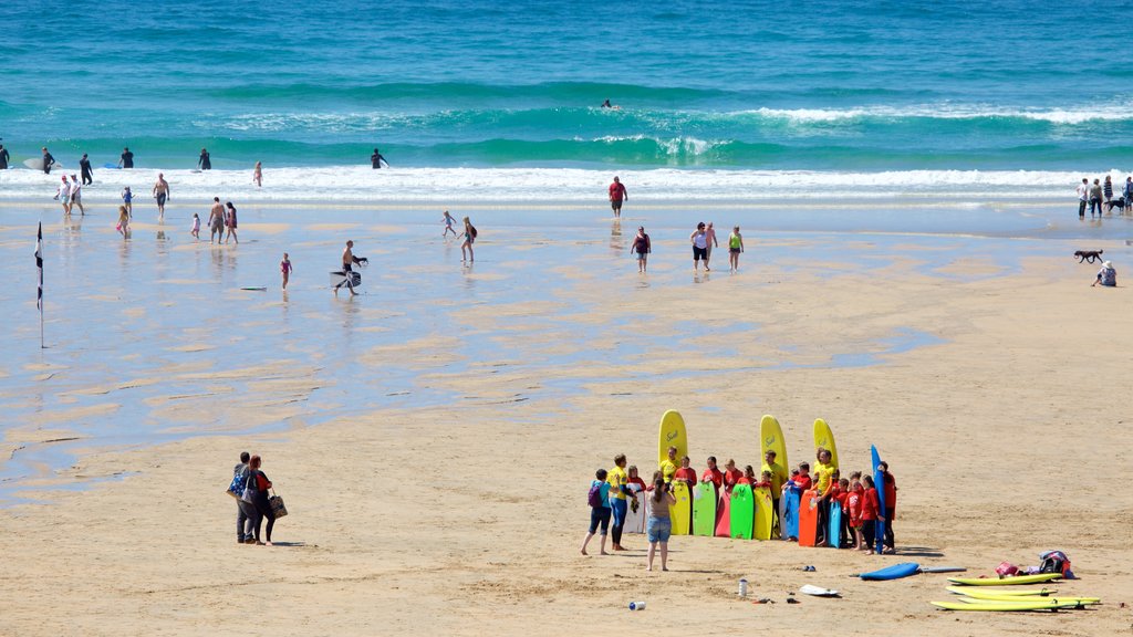 Fistral Beach featuring a beach and swimming as well as a large group of people