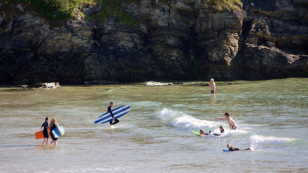 Porth Beach showing surfing, a sandy beach and swimming