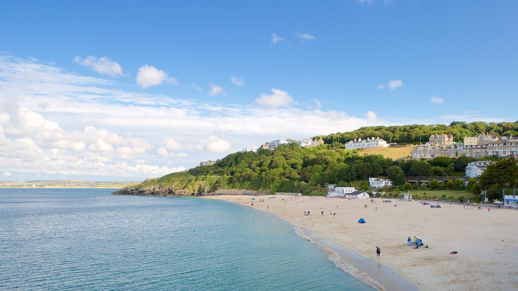 Porthminster Beach featuring a sandy beach and a coastal town