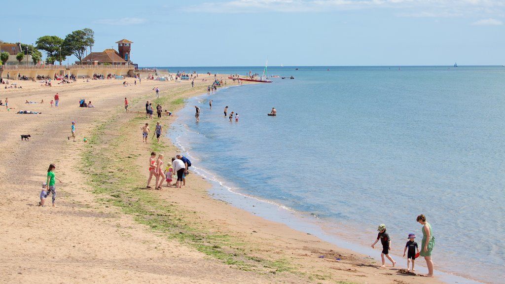 Exmouth showing a beach and swimming as well as a large group of people