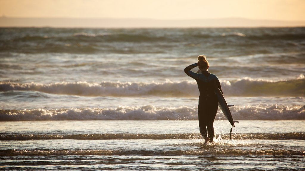 Woolacombe showing surfing and waves as well as an individual female