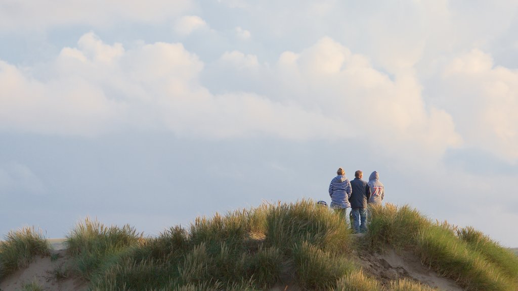 Woolacombe which includes a sandy beach as well as a small group of people