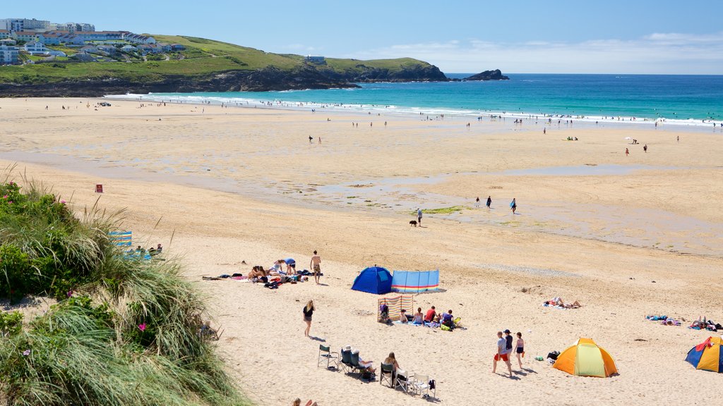 Fistral Beach featuring a sandy beach and rocky coastline